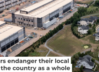 An Amazon data center sits next to a neighborhood in northern Virginia. Nathan Howard/Getty Images